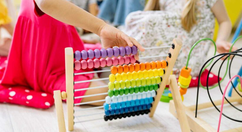 A child plays with an abacus