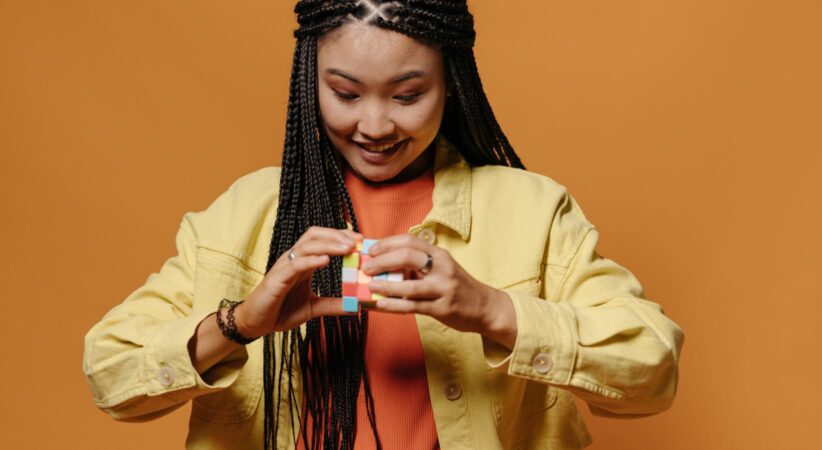 Woman tries to solve a rubik's cube.
