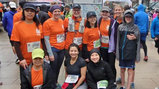 A group of people standing together at the Vancouver Sun Run 2023. 
