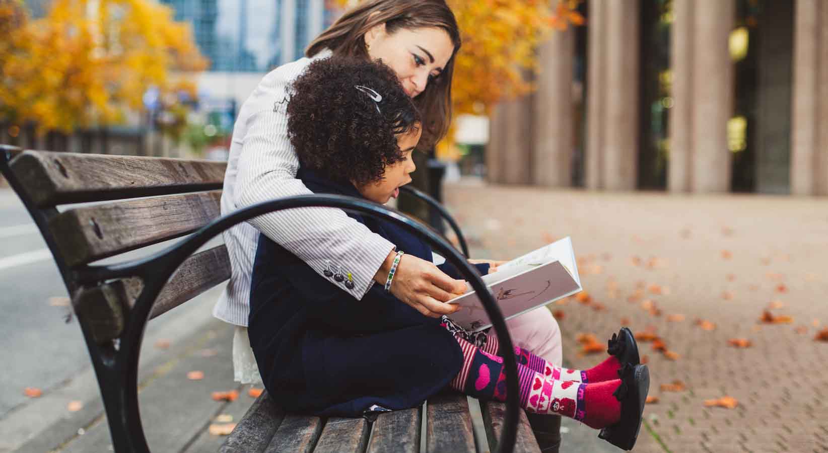 Woman and child reading on a bench